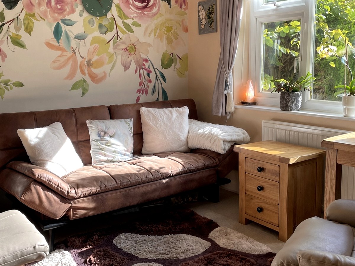 Catherine's counselling room, with a sofa, armchair and warm natural light.